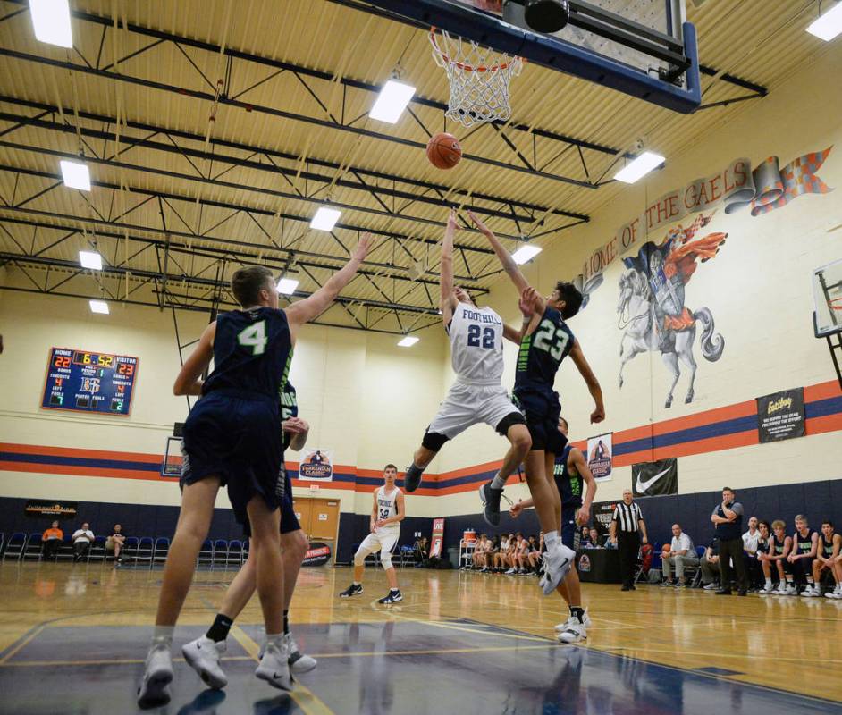 Foothill’s Jace Roquemore (22) takes a shot while under pressure from Timpanogos&#8217 ...