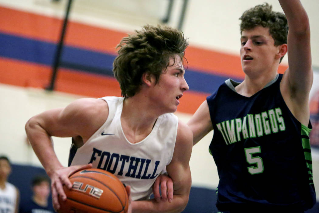 Foothill’s Collin Russell (3), left, dribbles the ball against Timpanogos’ Trey ...