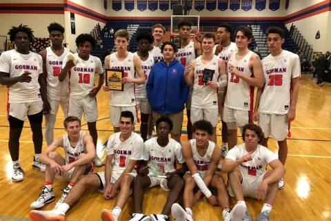 Bishop Gorman boys basketball players pose for photos after a 61-39 home victory over Rancho ...