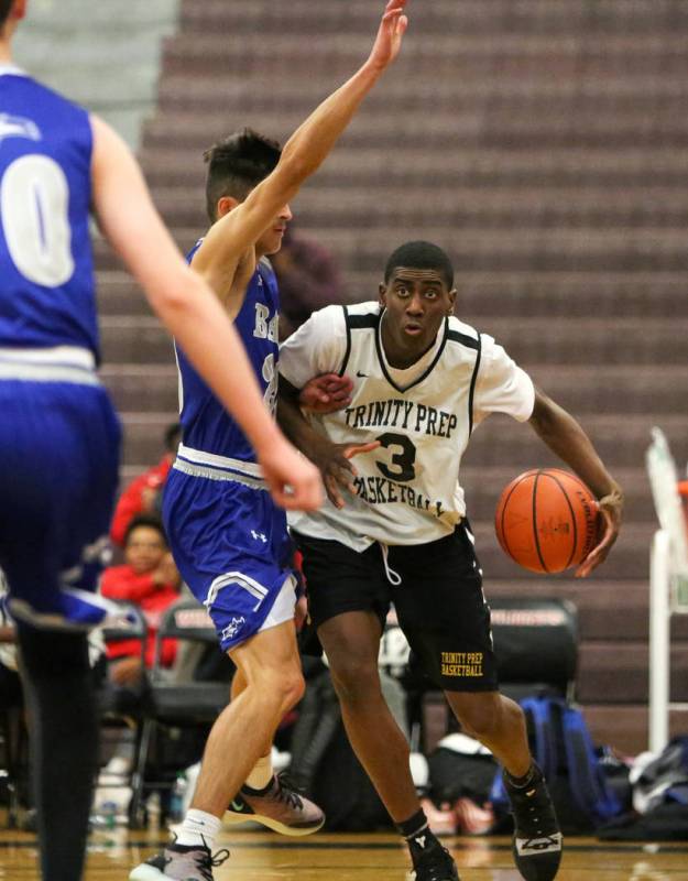 Trinity’s Kevin Giles (3) looks to pass the ball while under pressure from Basic&#8217 ...