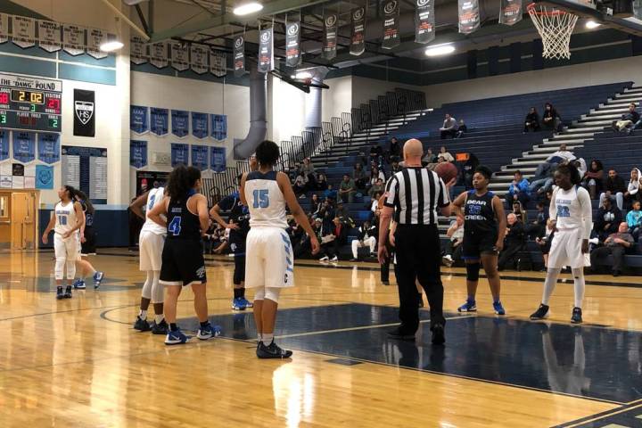 Centennial players line up alongside the lane as a Bear Creek player shoots a free throw at ...