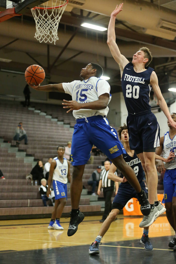 Trinity’s Milton Burnett (15) jumps for a shot under pressure from Foothill’s Ca ...