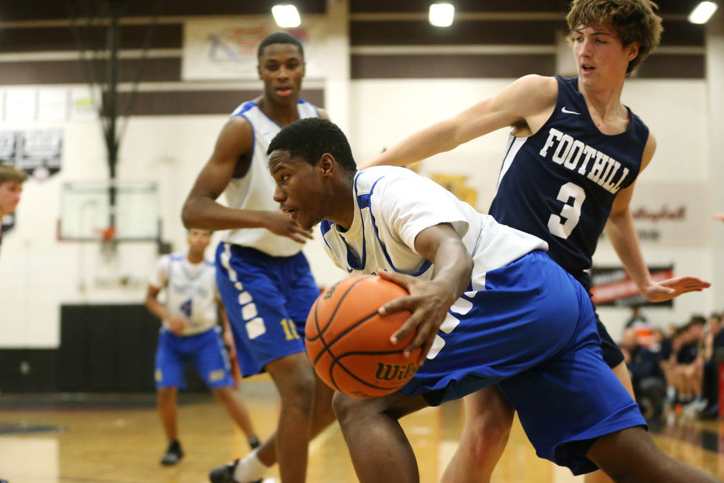 Trinity’s Milton Burnett (15) drives the ball around Foothill’s Collin Russell ( ...