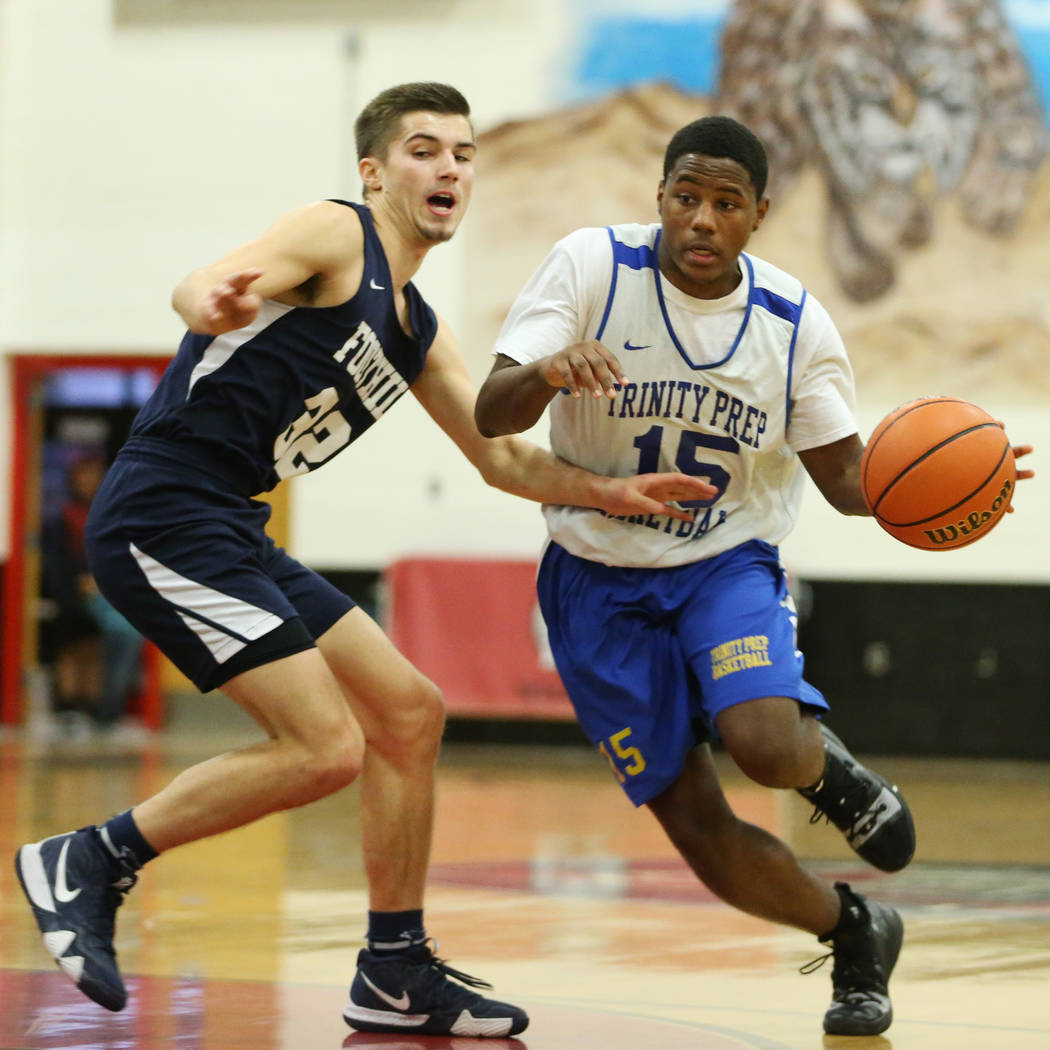 Trinity’s Milton Burnett (15) drives the ball under pressure from Foothill’s Dyl ...