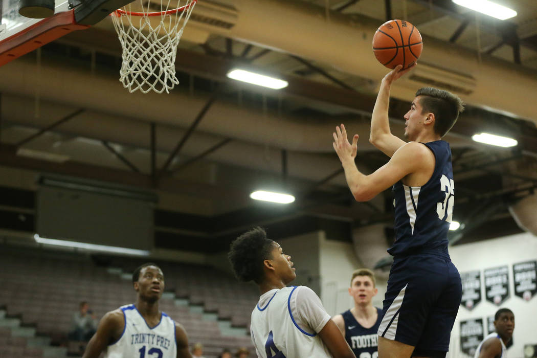 Foothill’s Dylan Hushaw (32) takes a shot over Trinity’s Jose Cuello (4) in the ...