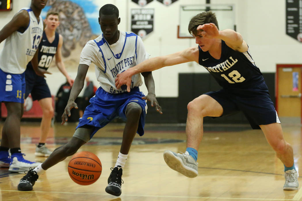 Trinity’s Madait Mou (2) steals the ball from Foothill’s Fisher Welch (12) in th ...
