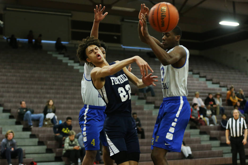 Foothill’s Jace Rocequemore (22) makes a pass under pressure from Trinity’s Kevi ...
