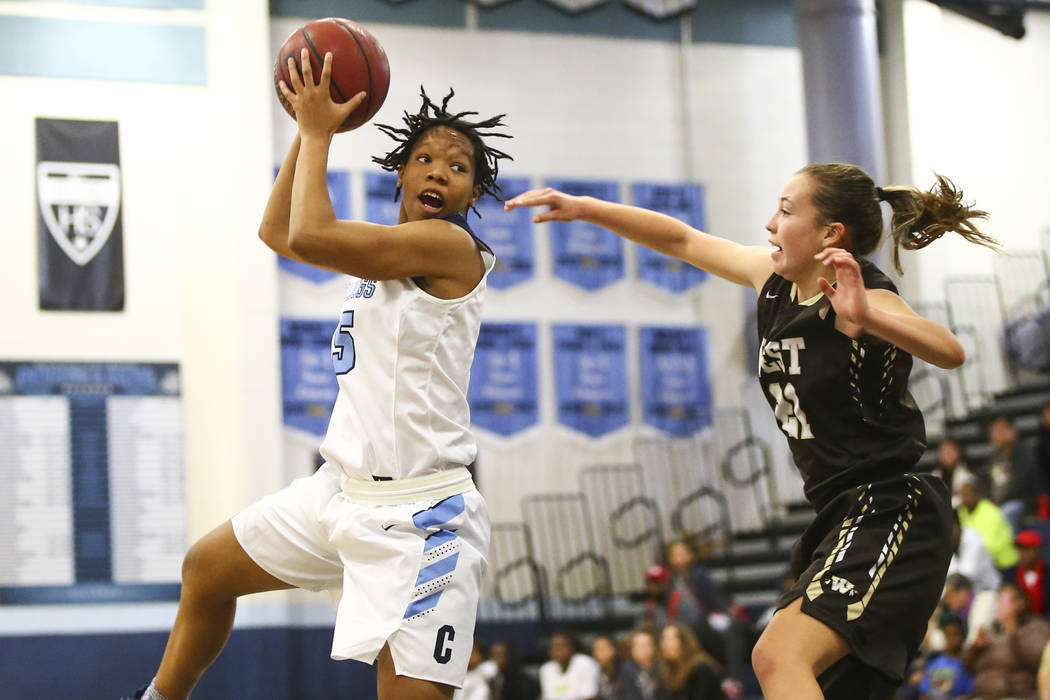 Centennial’s Daejah Phillips (15) looks to pass under pressure from West’s Ella ...