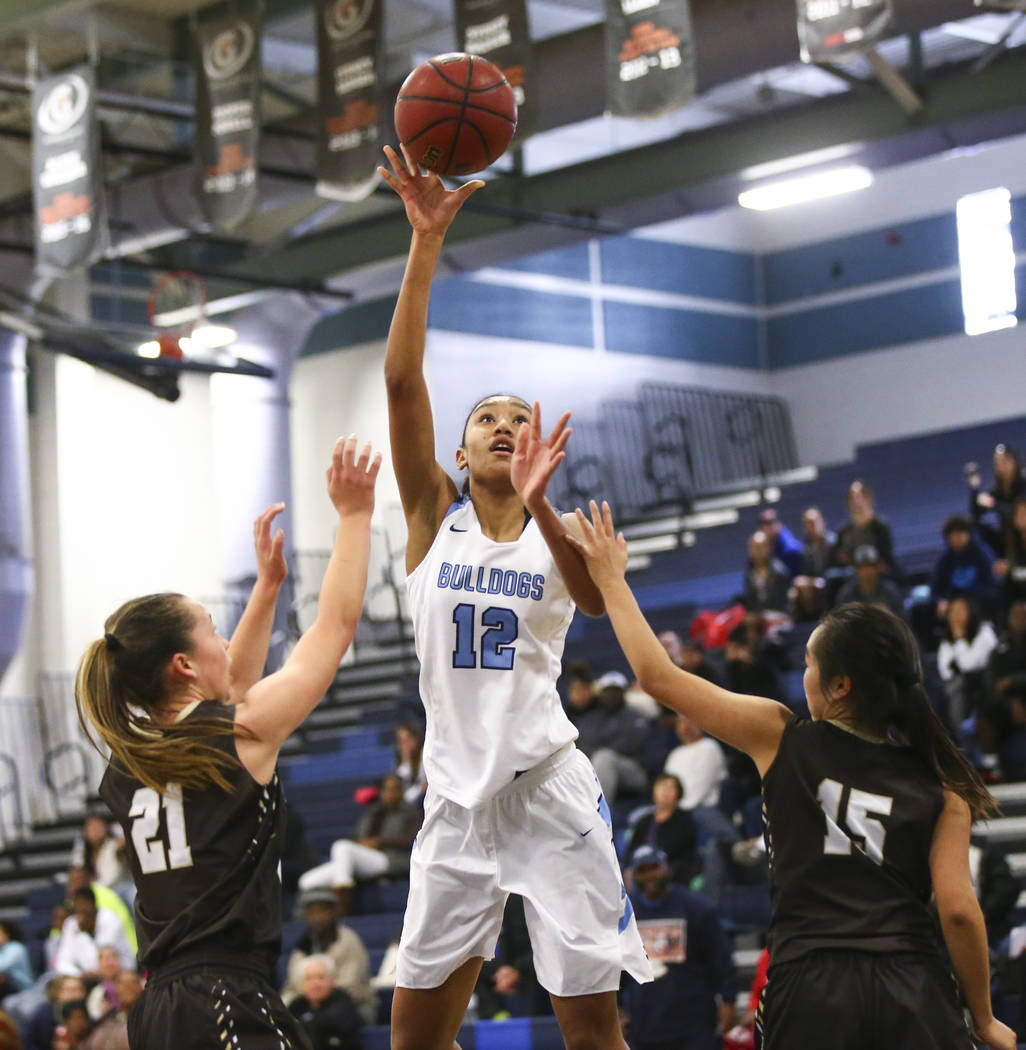 Centennial’s Aishah Brown (12) shoots between WestÕs Ella Estabrook (21) and WestR ...