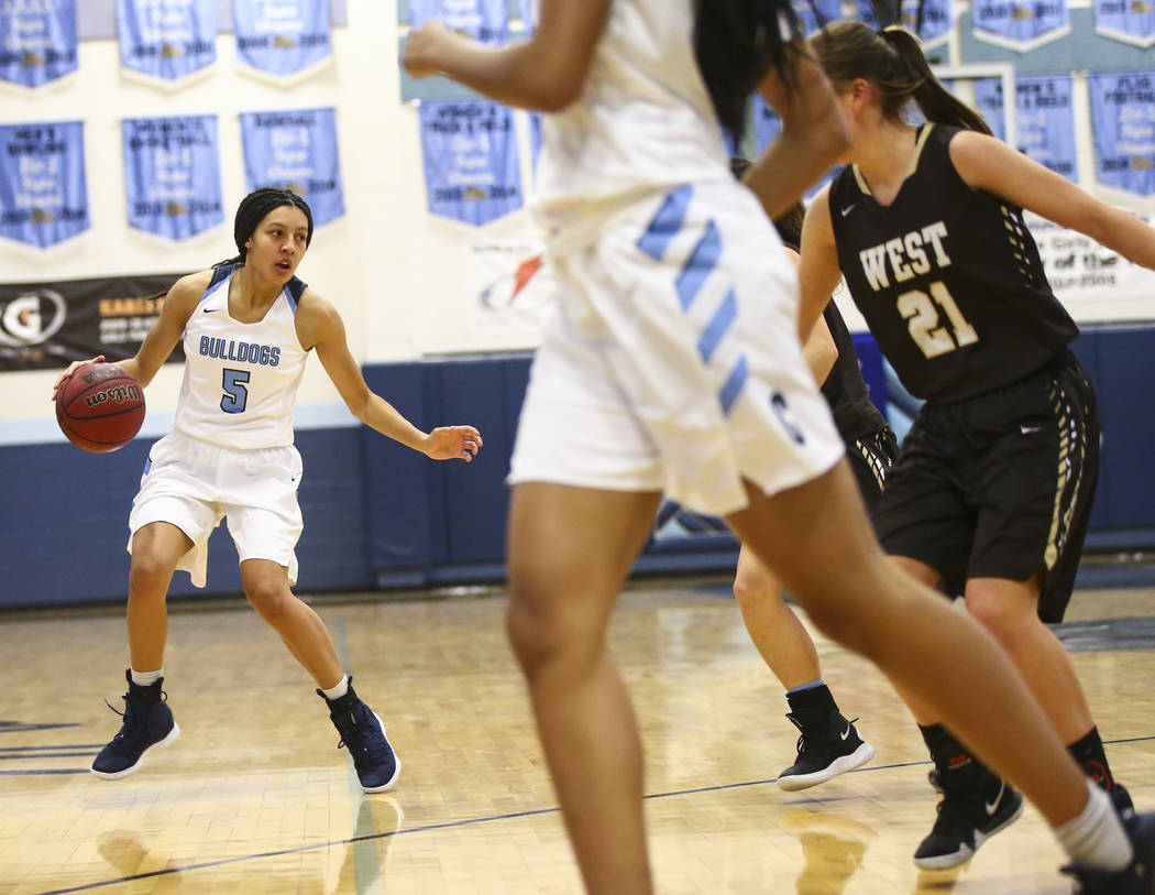 Centennial’s Jade Thomas (5) moves the ball against West during a basketball game at C ...
