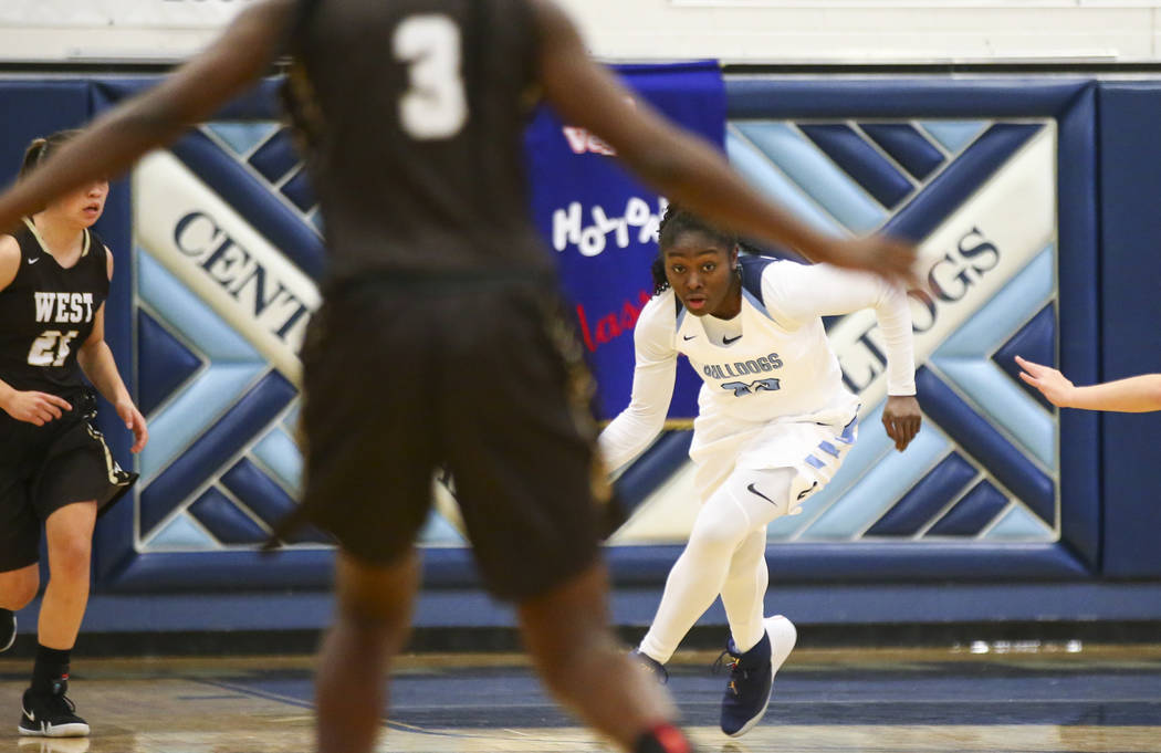 Centennial’s Eboni Walker (22) brings the ball up court against West during a basketba ...
