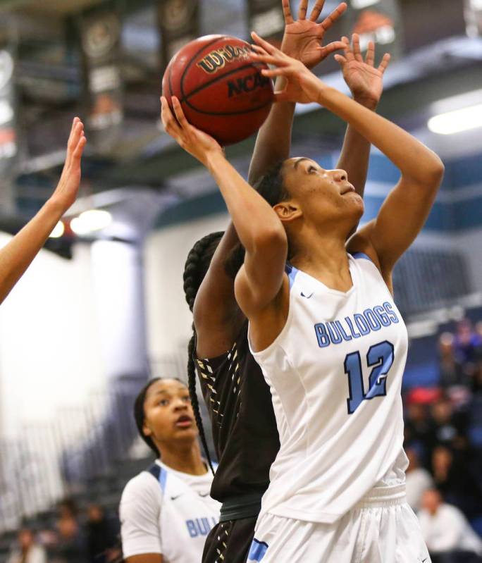 Centennial’s Aishah Brown (12) looks to shoot against West during a basketball game at ...