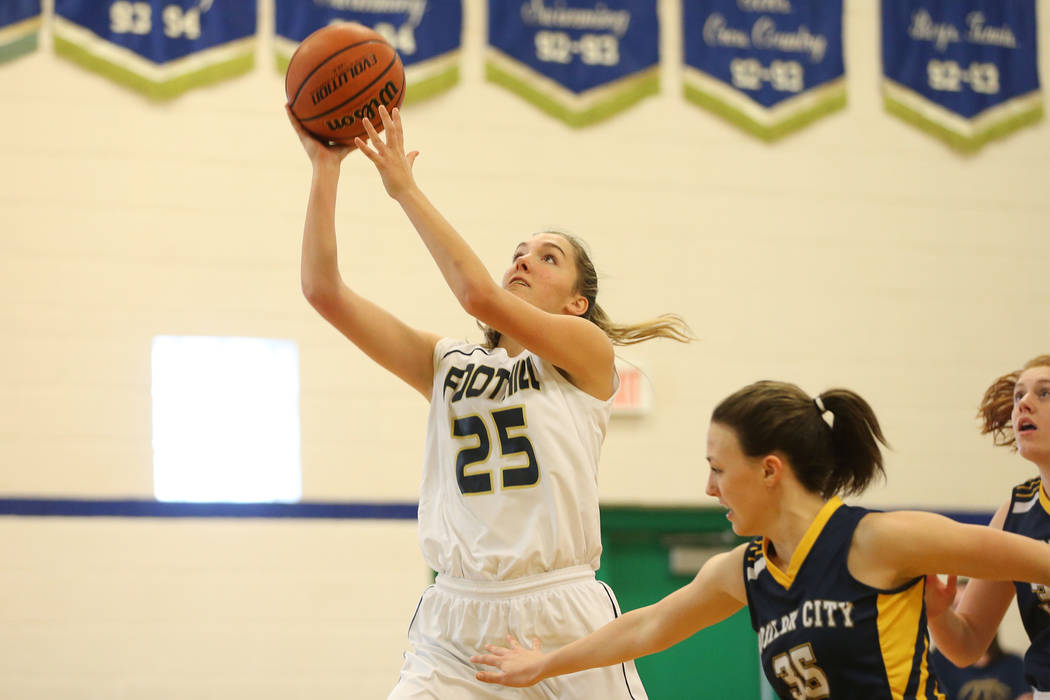 Foothill’s Maddy Beckham (25) shoots against Boulder City’s Hannah Estes (35) in ...