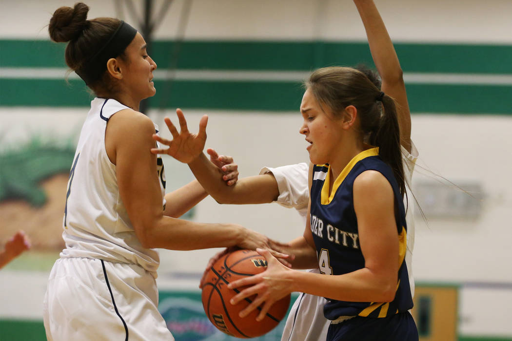 Boulder City’s Keely Alexander (14) is pressured by Foothill’s Yareth Arse (4) i ...
