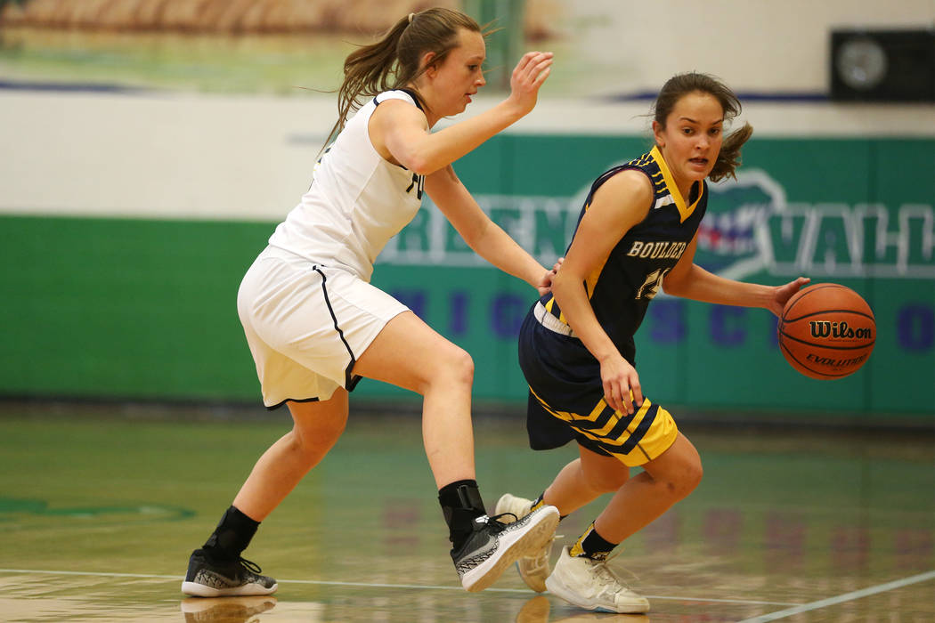 Boulder City’s Keely Alexander (14) dribbles the ball up the court as she is pressured ...
