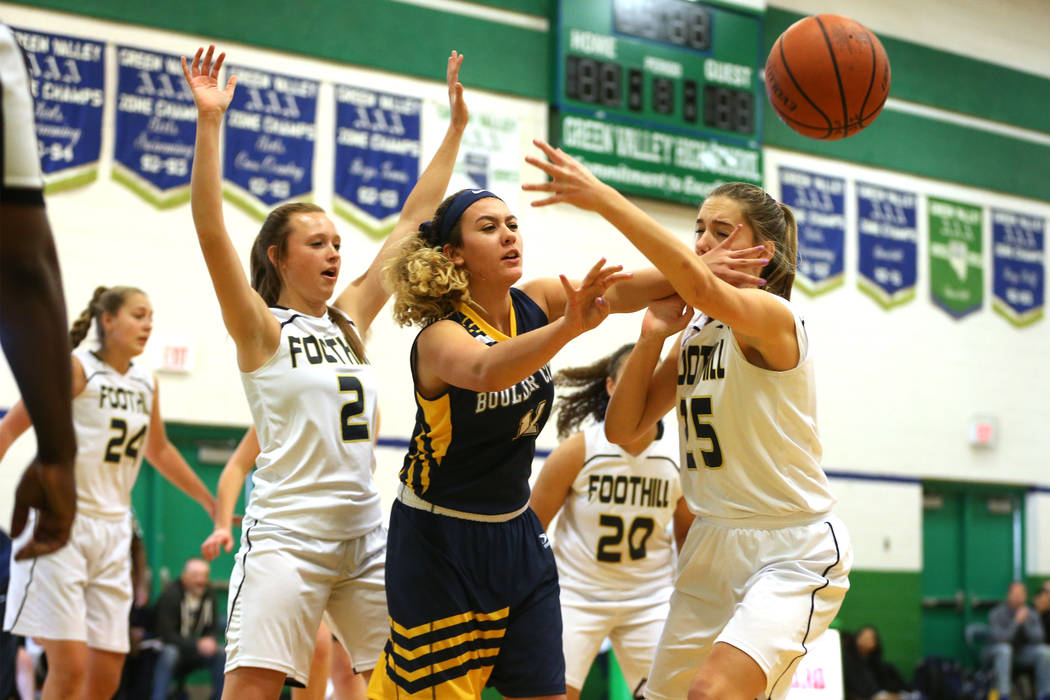 Boulder City’s Kailee Fisher (11) makes a pass under pressure from Foothill’s Aq ...