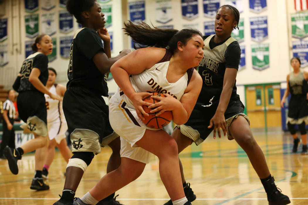 Dimond’s Kayla Pili (32) is pressured by Spring Valley’s Aaliyah Gayles (3) in t ...