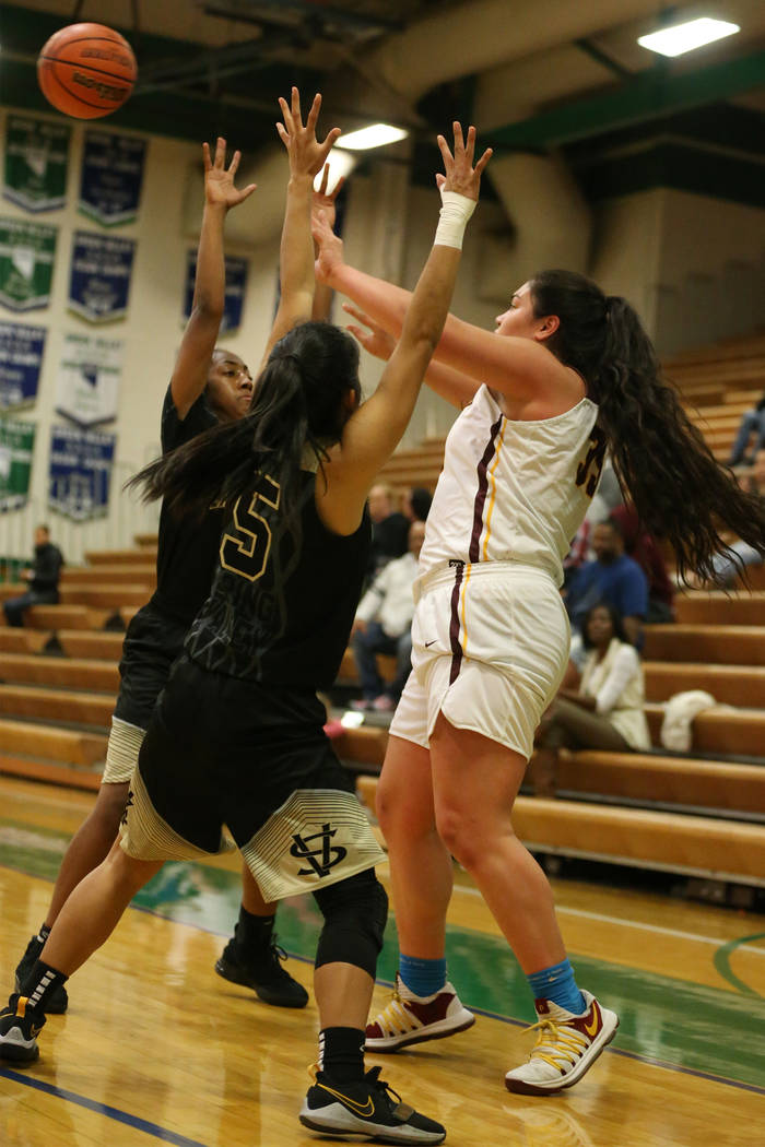 Dimond’s Alissa Pili (35) makes a pass under pressure from Spring Valley’s Aaliy ...
