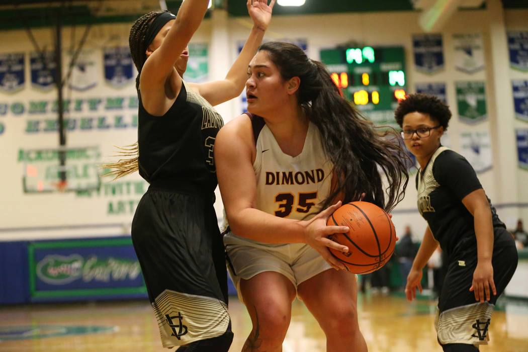 Dimond’s Alissa Pili (35) looks for an open pass against pressure from Spring Valley&# ...