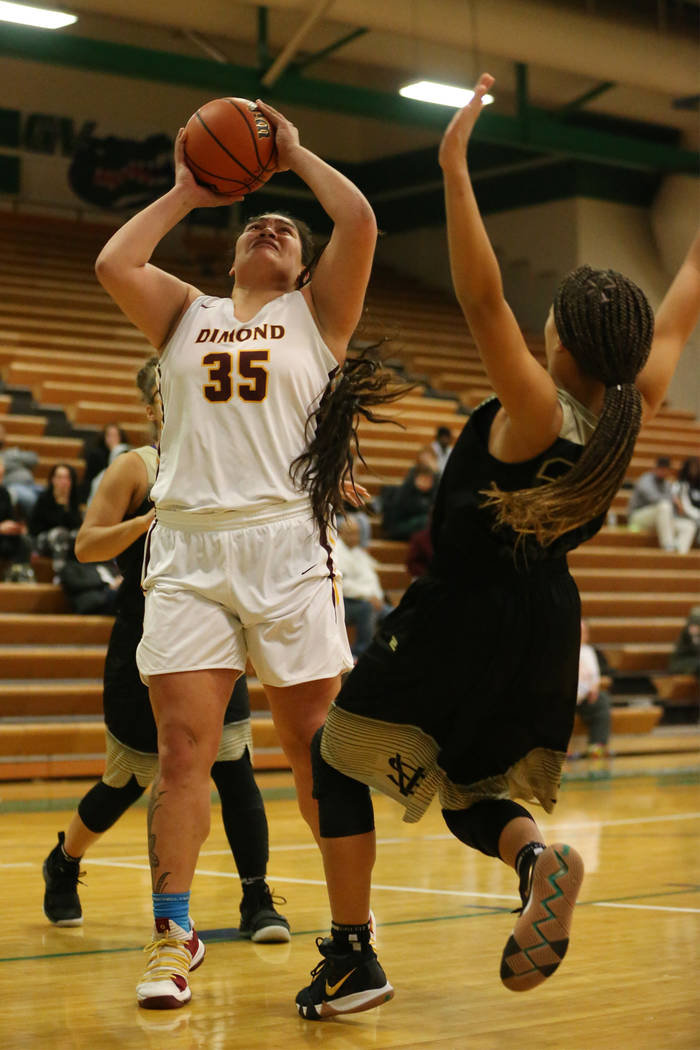 Dimond’s Alissa Pili (35) goes up for a shot before getting called for a charge agains ...