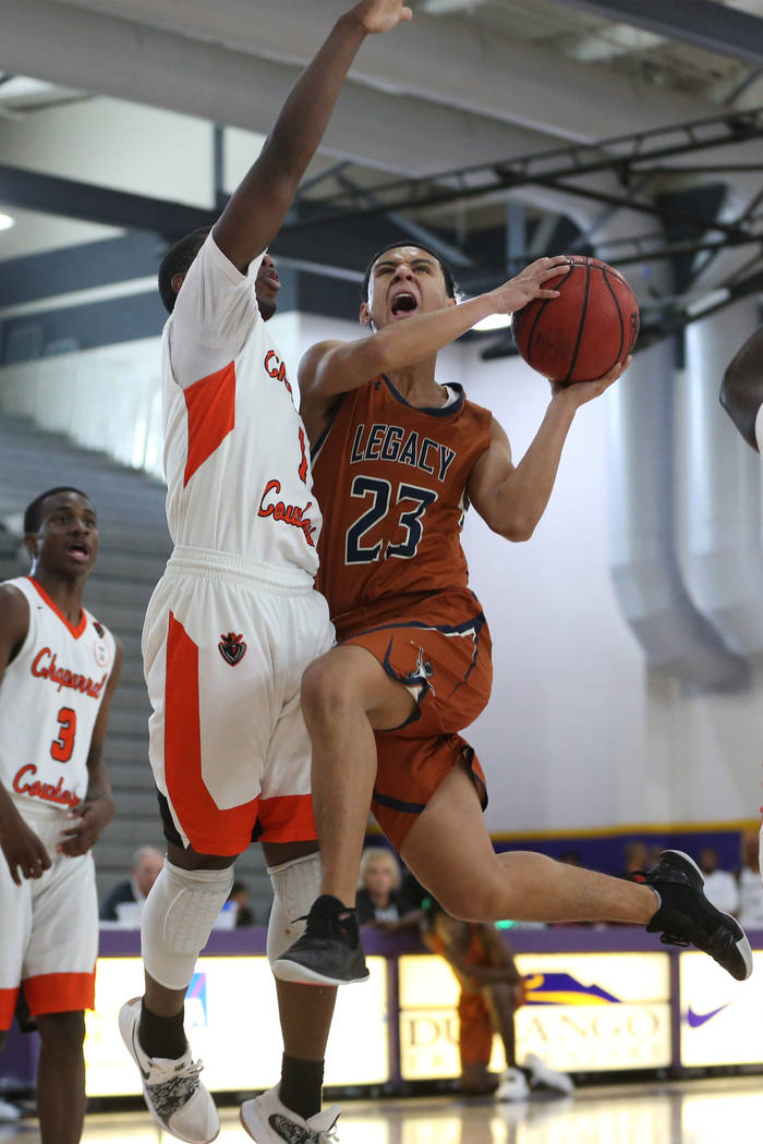 Legacy’s Andrew Garcia (23) goes up for a shot against Chaparral’s Meshach Hawki ...