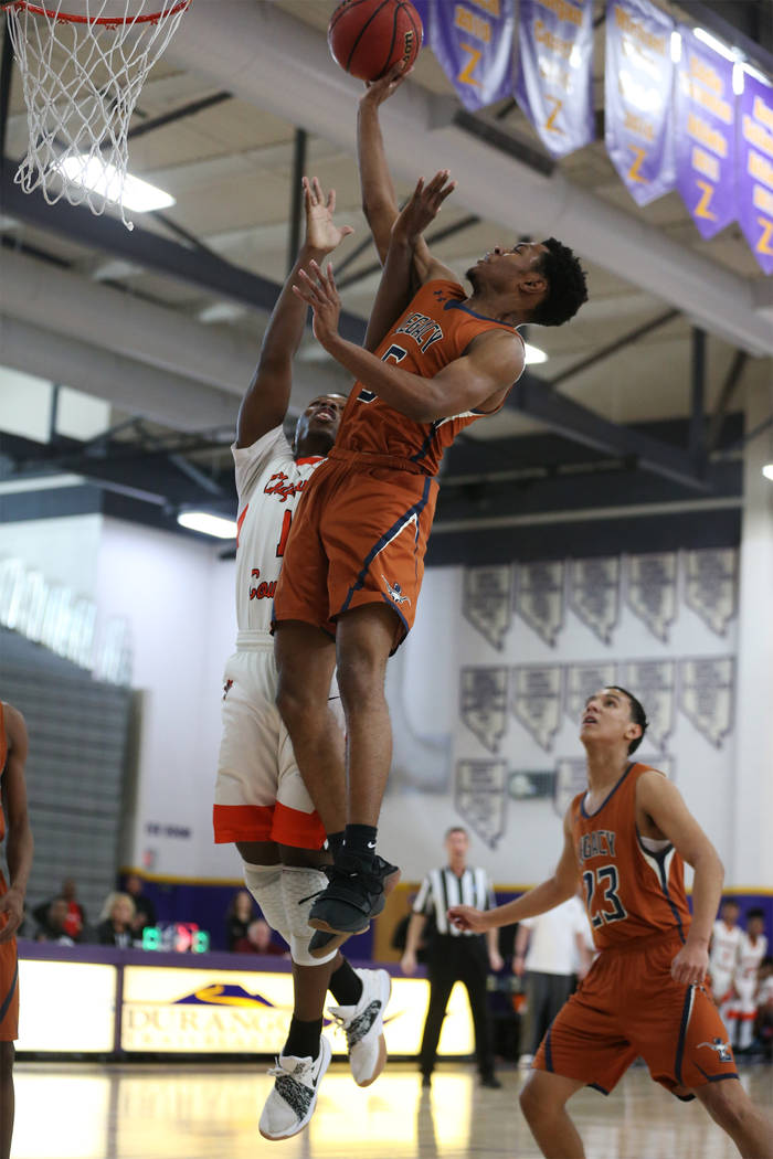 Legacy’s Jalen Johnson (5) goes up for a shot against Chaparral’s Meshach Hawkin ...