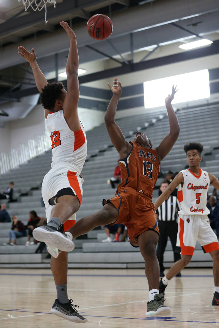 Legacy’s Aaron Holloway (13) takes a shot as he is fouled by Chaparral’s Iopu Ta ...