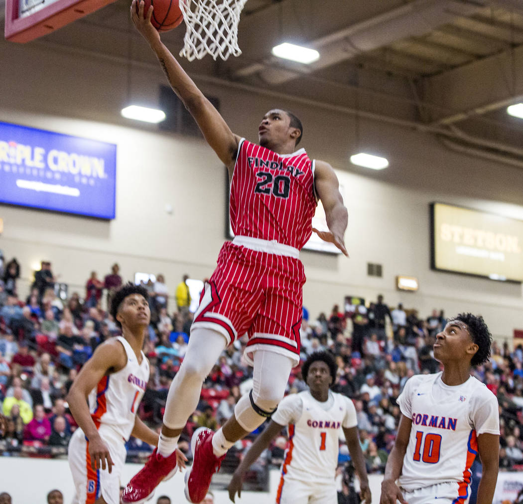 Findlay Prep’s Reggie Chaney (20) looks to make a layup while Bishop Gorman’s Is ...