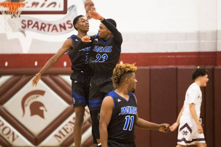 Desert Pines sophomore Dayshawn Wiley (2) celebrates with teammate Darnell Washington (13 af ...