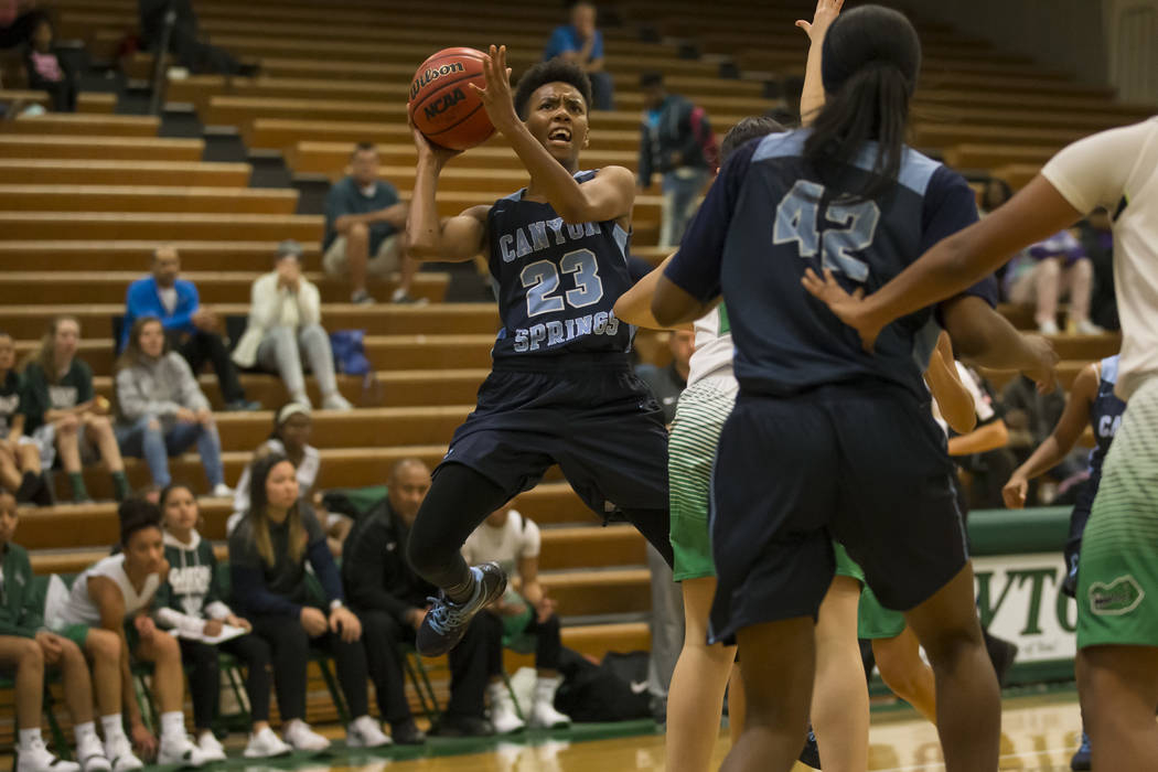 Canyon Springs guard Kayla Johnson (23) takes a shot against Green Valley during the first h ...