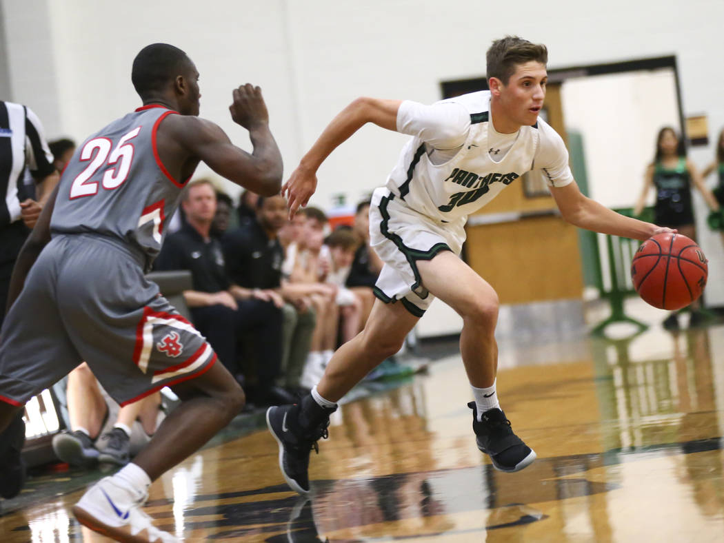 Palo Verde’s Drew Warnick (30) drives the ball past Arbor View’s Larry Holmes (2 ...