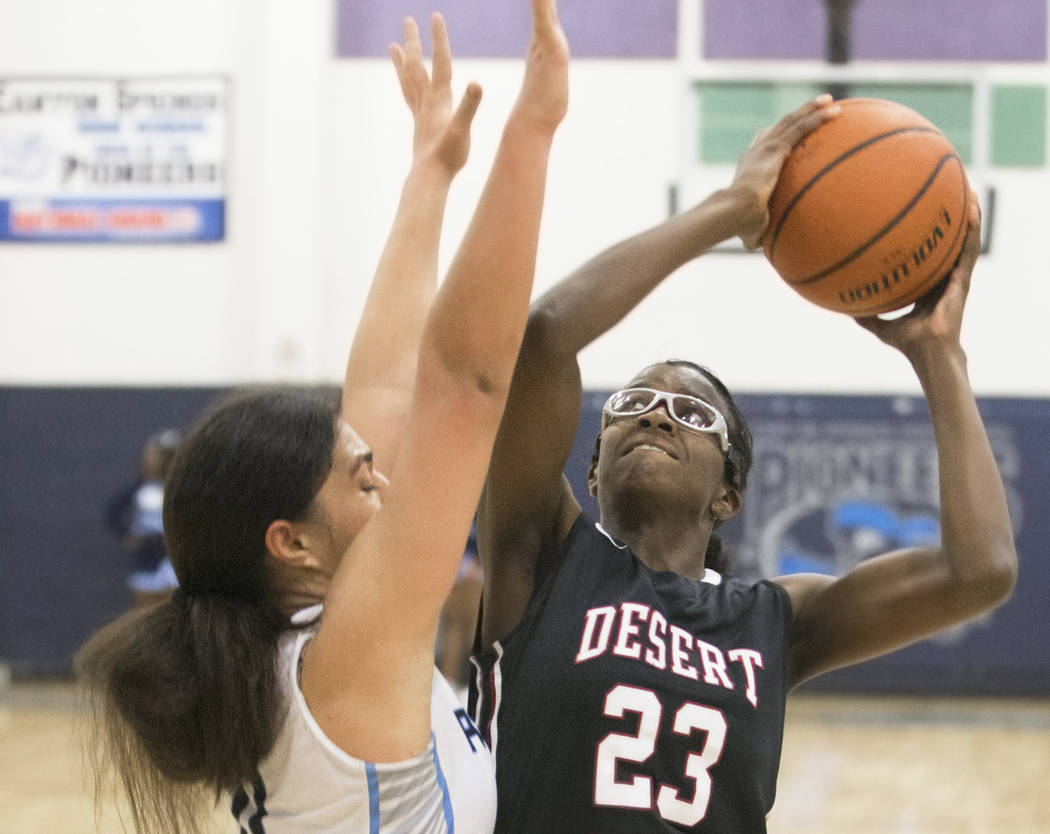 Desert Oasis junior center Desi-Rae Young (23) shoots over Canyon Springs junior forward Jea ...