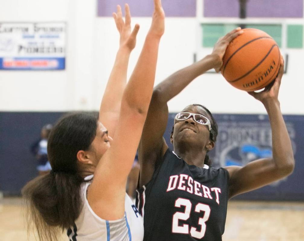 Desert Oasis junior center Desi-Rae Young (23) shoots over Canyon Springs junior forward Jea ...
