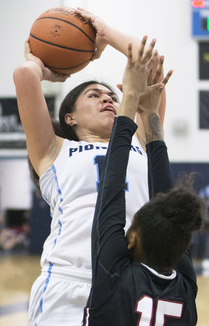 Canyon Springs junior forward Jeanette Fine (11) drives past Desert Oasis senior forward Ahm ...