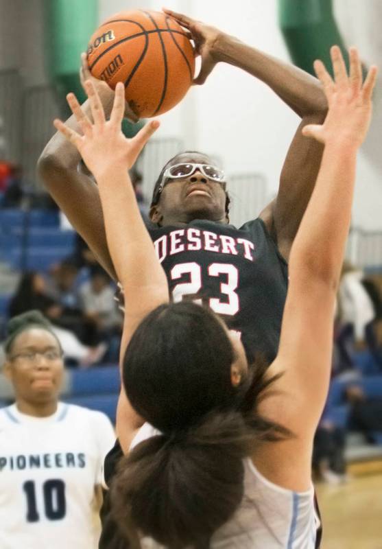 Desert Oasis junior center Desi-Rae Young (23) shoots over Canyon Springs junior forward Jea ...