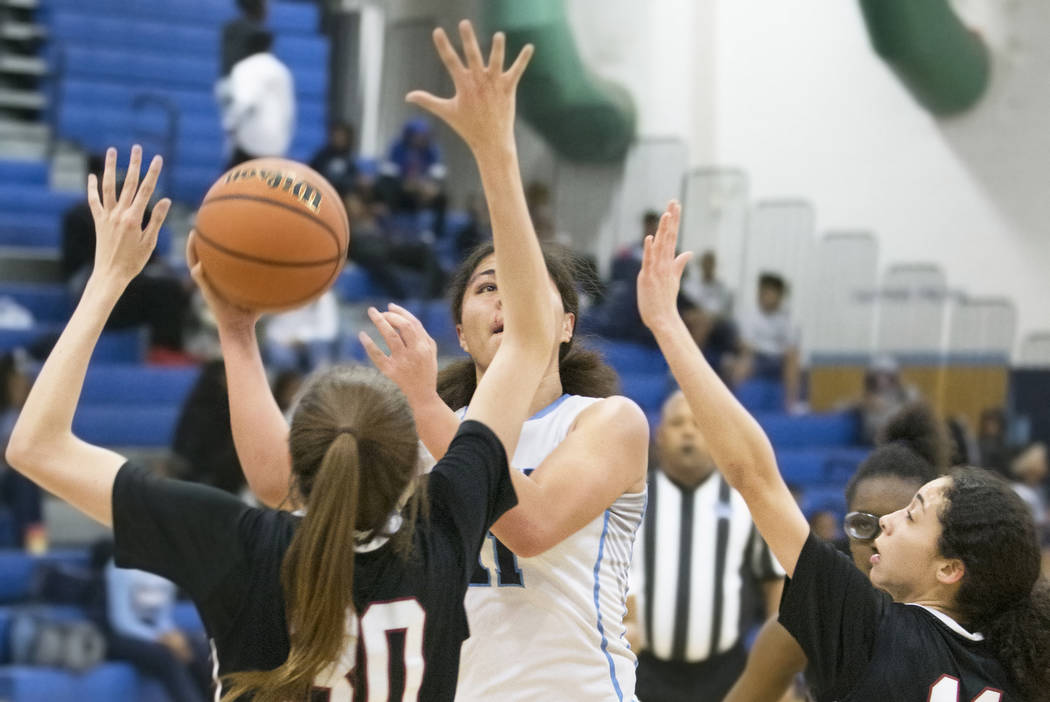 Canyon Springs junior forward Jeanette Fine (11) shoots over Desert Oasis senior forward Sie ...