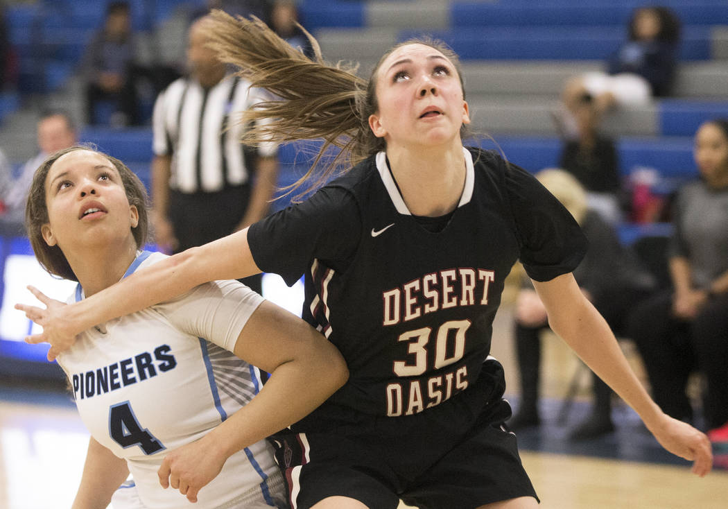 Desert Oasis senior forward Sierra Mich’l (30) boxes out Canyon Springs senior guard J ...