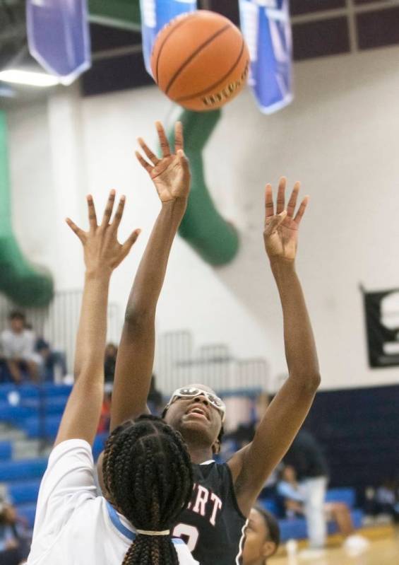 Desert Oasis junior center Desi-Rae Young (23) shoots over Canyon Springs junior center Broo ...