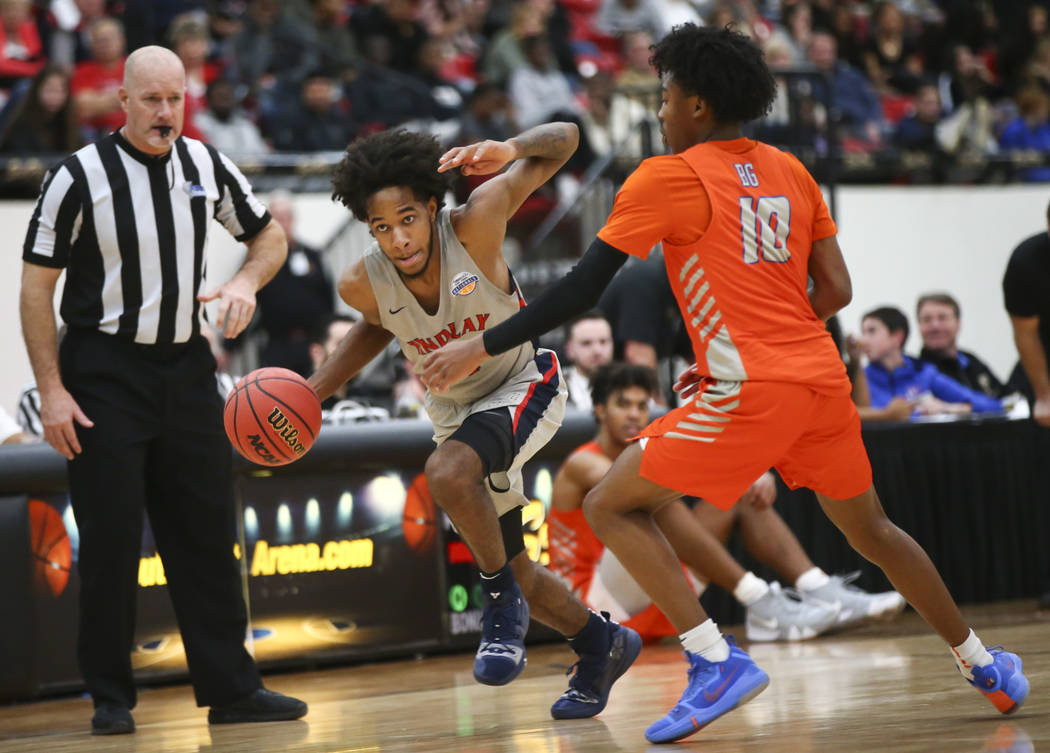 Findlay Prep’s P.J. Fuller drives the ball against Bishop Gorman’s Zaon Collins ...