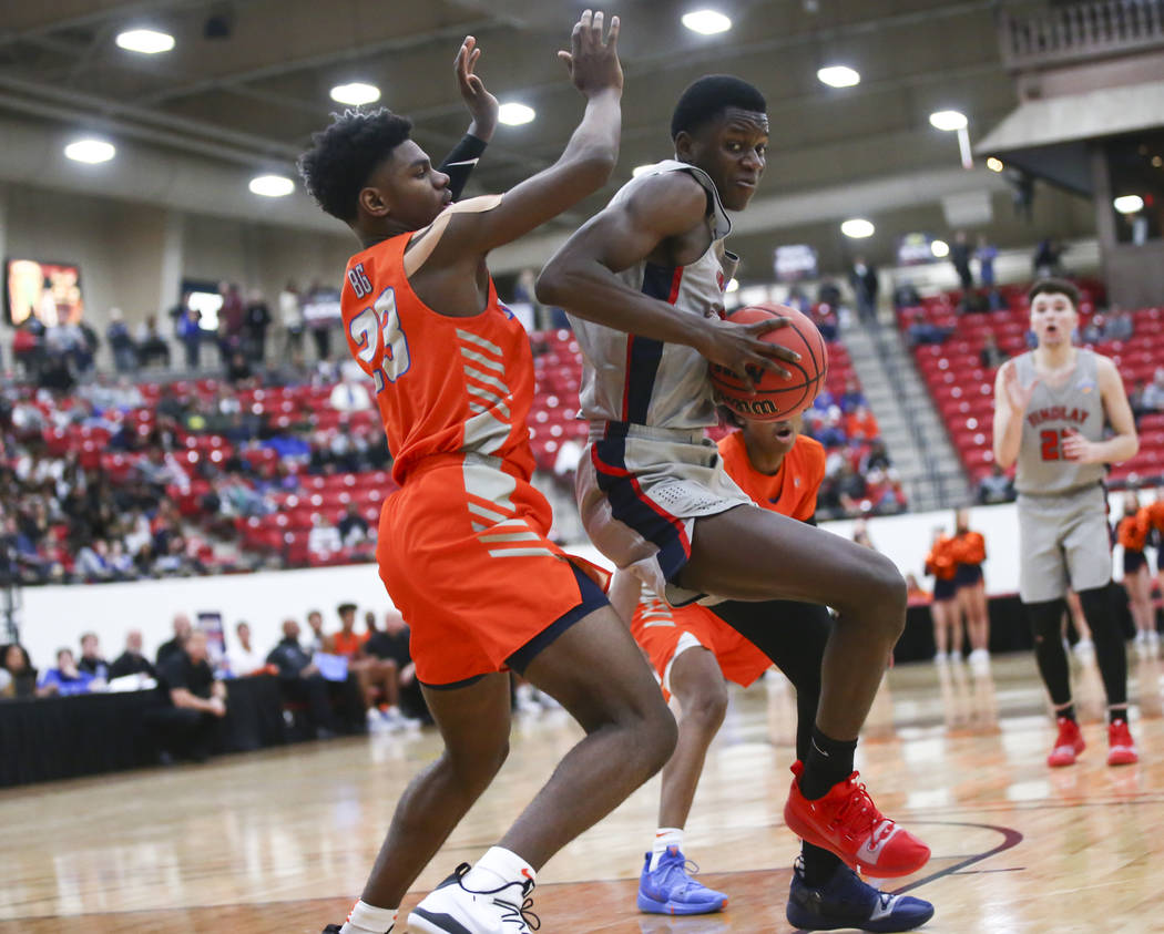 Findlay Prep’s Alex Tchikou, right, moves the ball around Bishop Gorman’s Mwani ...