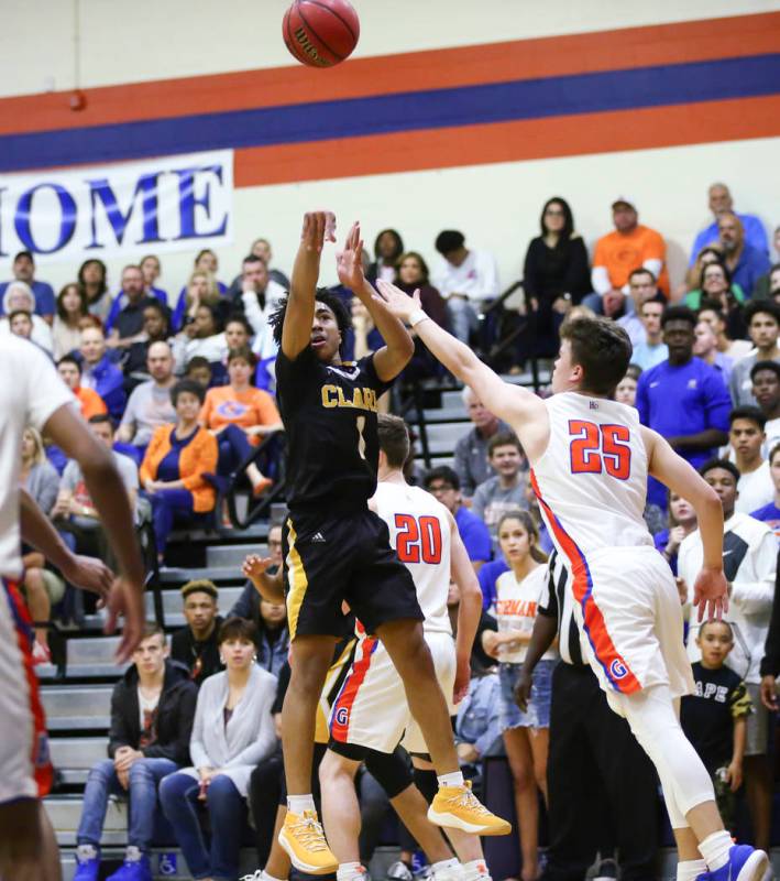 Clark’s Frankie Collins (1) shoots over Bishop Gorman’s Chance Michels (25) duri ...