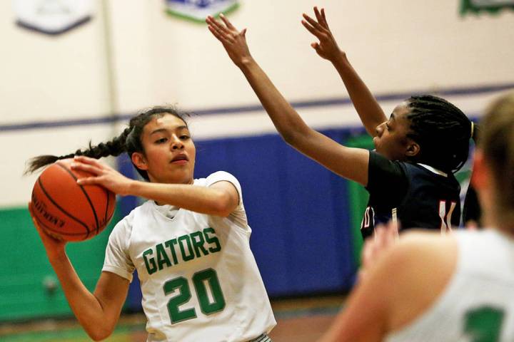 Green Valley High School’s Michelle Lagunas-Monroy (20) tries to pass through Coronado ...