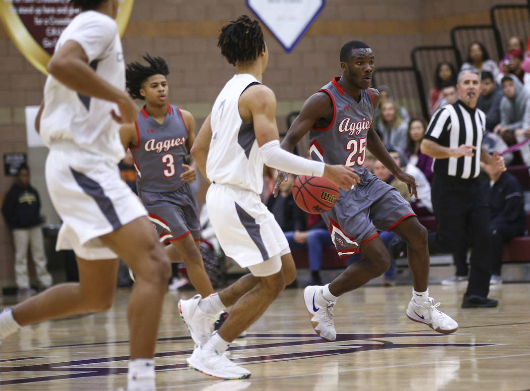 Arbor View’s Larry Holmes (25) brings the ball up court during the first half of a bas ...