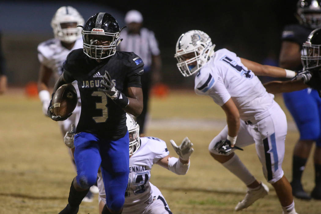 Desert Pines High School’s Jamel Brown (3) runs with the ball after dodging a tackle f ...