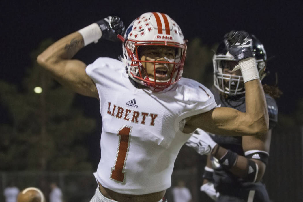Liberty senior wide receiver Cervontes White (1) flexes after getting a pass interference ca ...