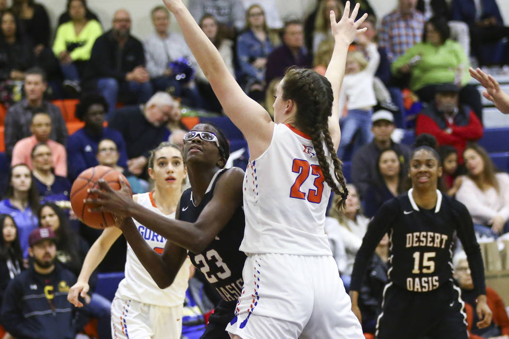 Desert Oasis’ Desi-Rae Young, left, looks to shoot against Bishop Gorman’s Tiern ...