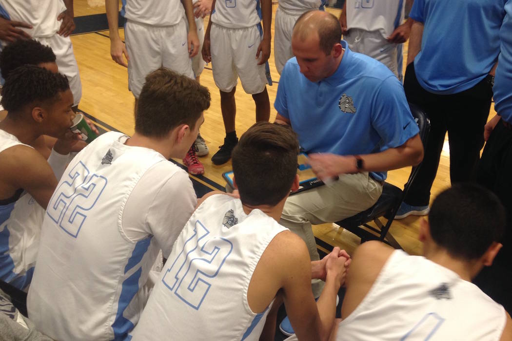 Centennial coach Noah Hartsock draws up a play during a timeout in the first quarter of Cent ...