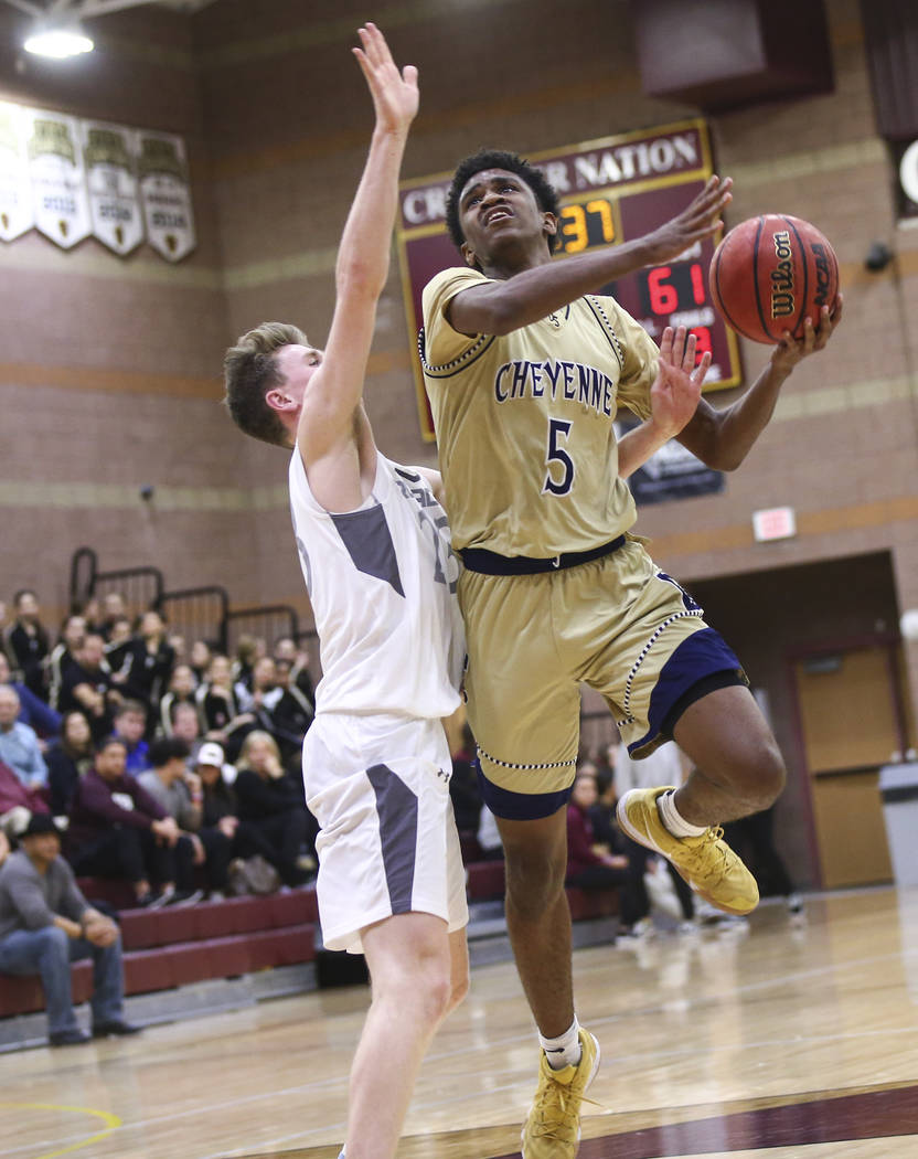 Cheyenne’s Glenn Taylor (5) mvoes the ball around Faith Lutheran’s Brevin Walter ...