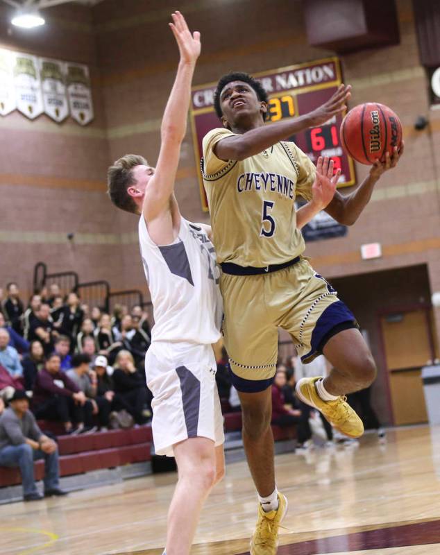 Cheyenne’s Glenn Taylor (5) mvoes the ball around Faith Lutheran’s Brevin Walter ...