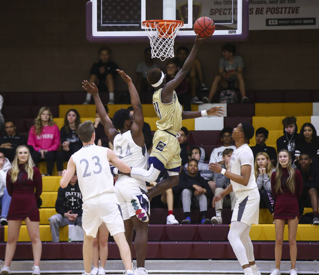 Cheyenne’s Tommie Lindsey (11) goes to the basket past Faith Lutheran’s D.J. Hec ...